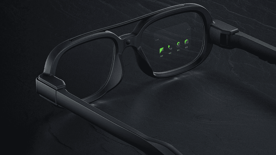 The Xiaomi smart glasses displaying green interface icons in the right lens.